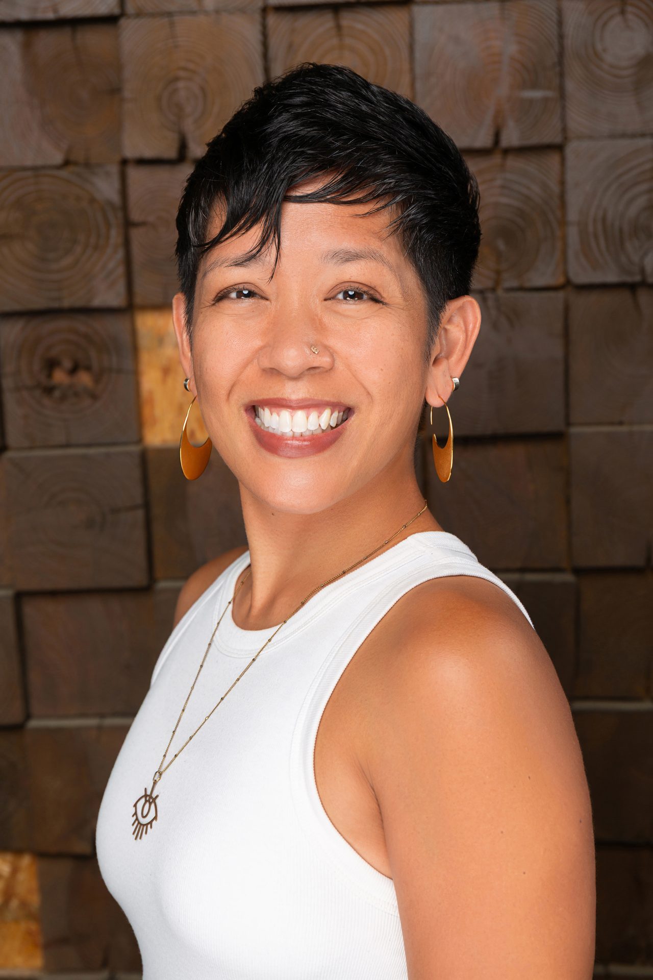 Corporate headshot of a smiling woman on a grey backdrop