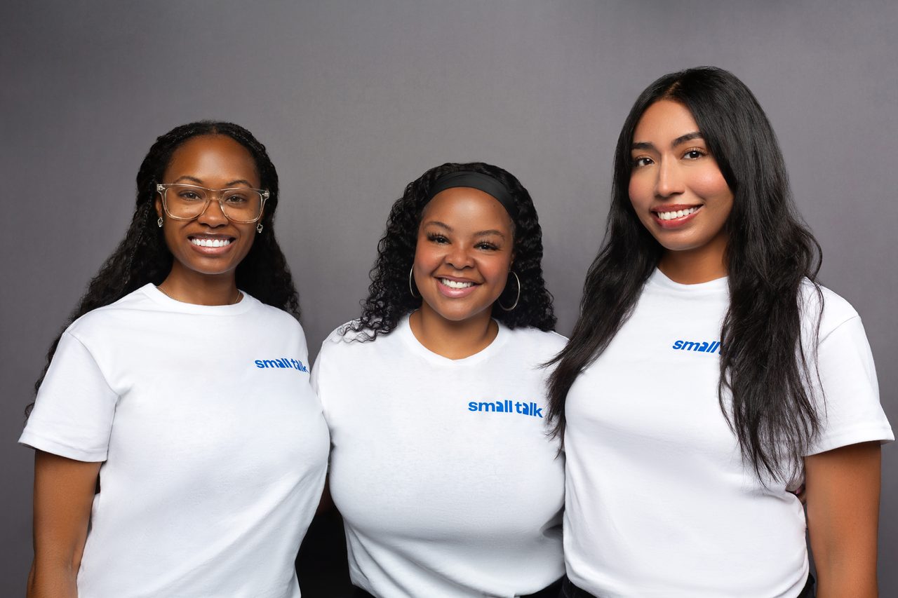 Three team members in matching white shirts