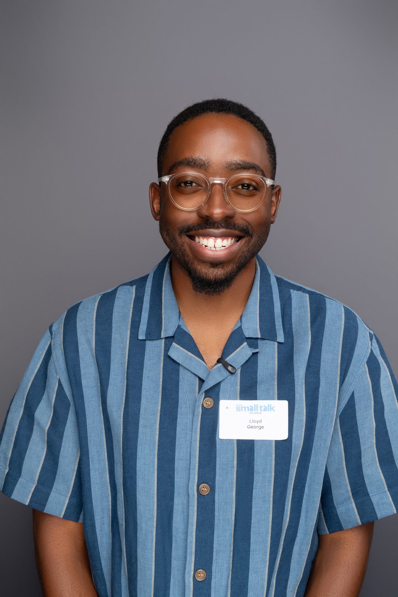 Headshot of a man in a striped shirt