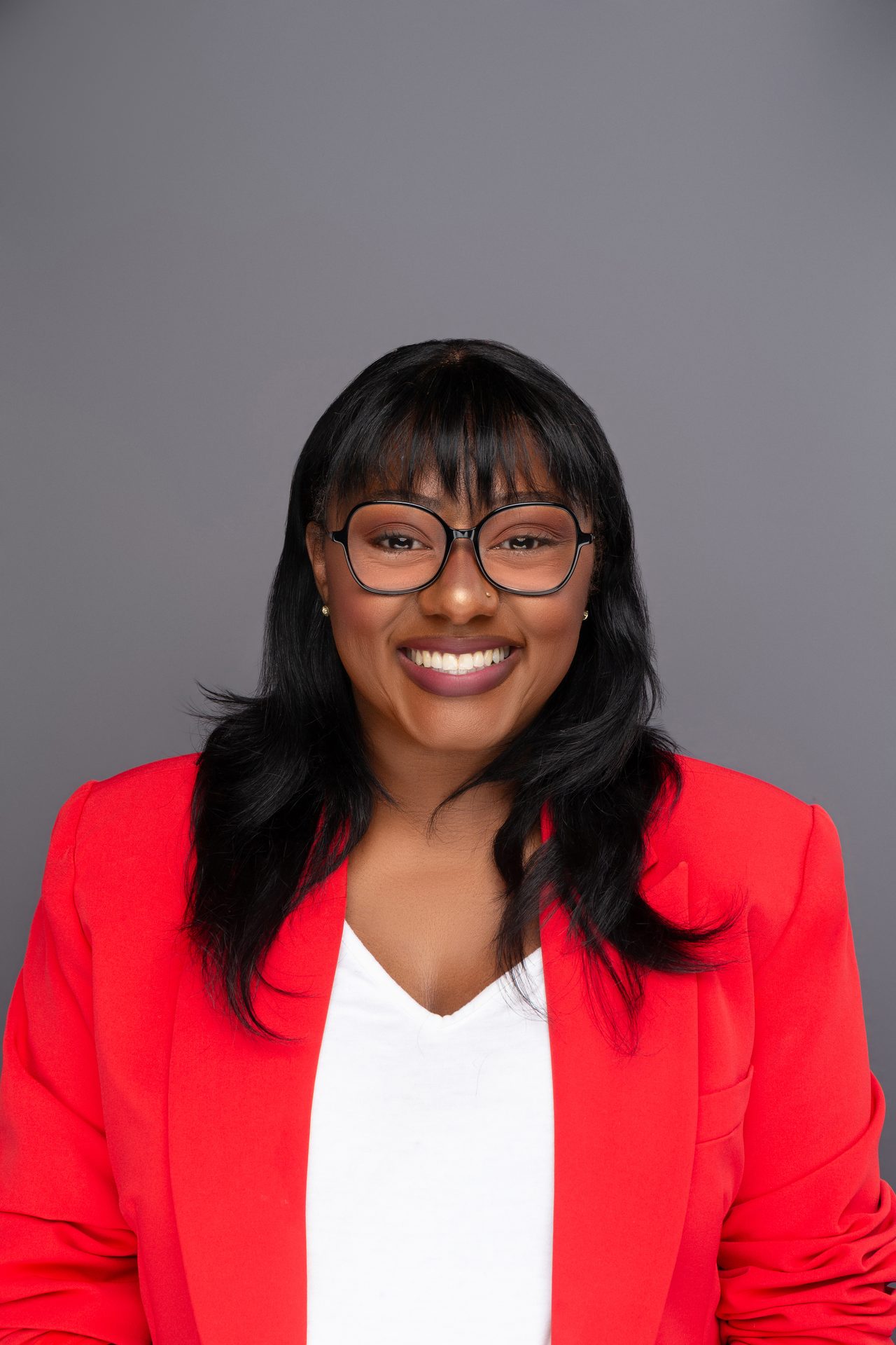 Headshot of a woman in a red blazer