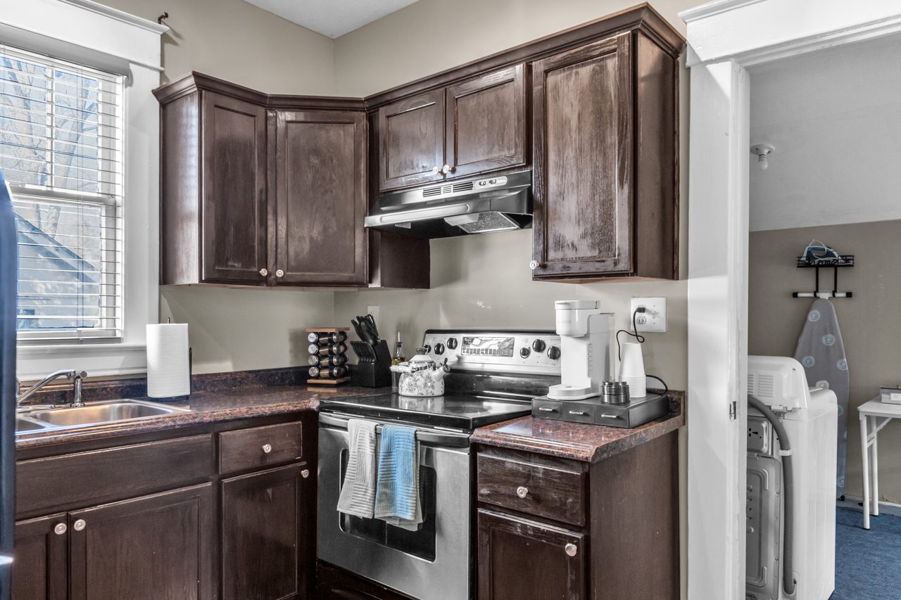 Kitchen with dark wood cabinets and stainless appliances