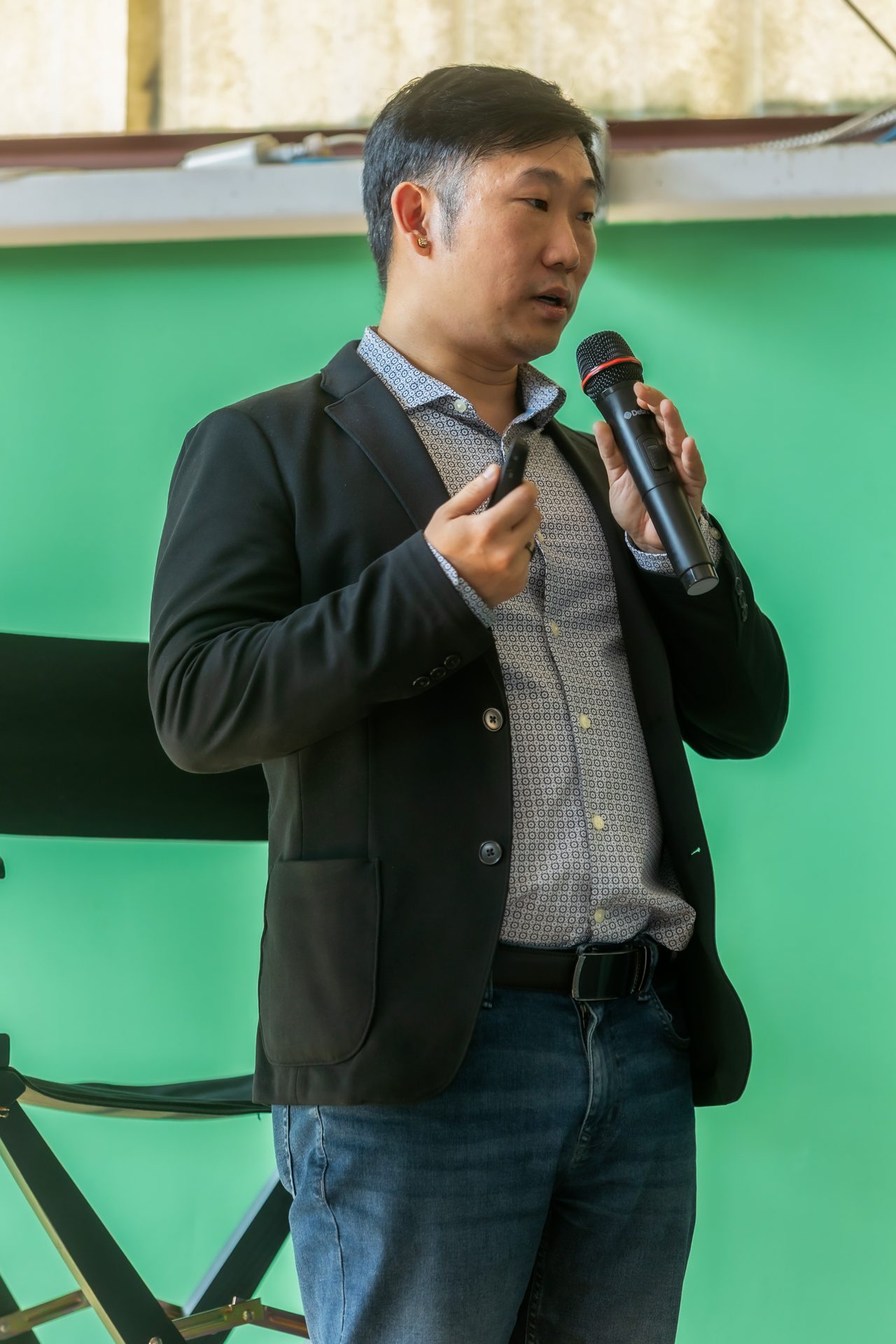 Speaker with a microphone addressing the room at FreshBooks Small Talk ATL