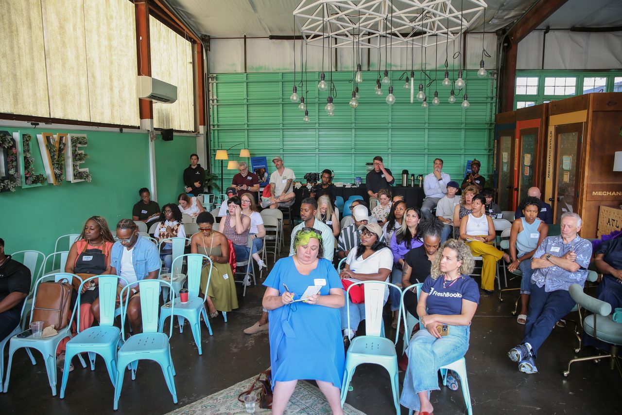 Wide view of a full audience and stage at FreshBooks Small Talk ATL