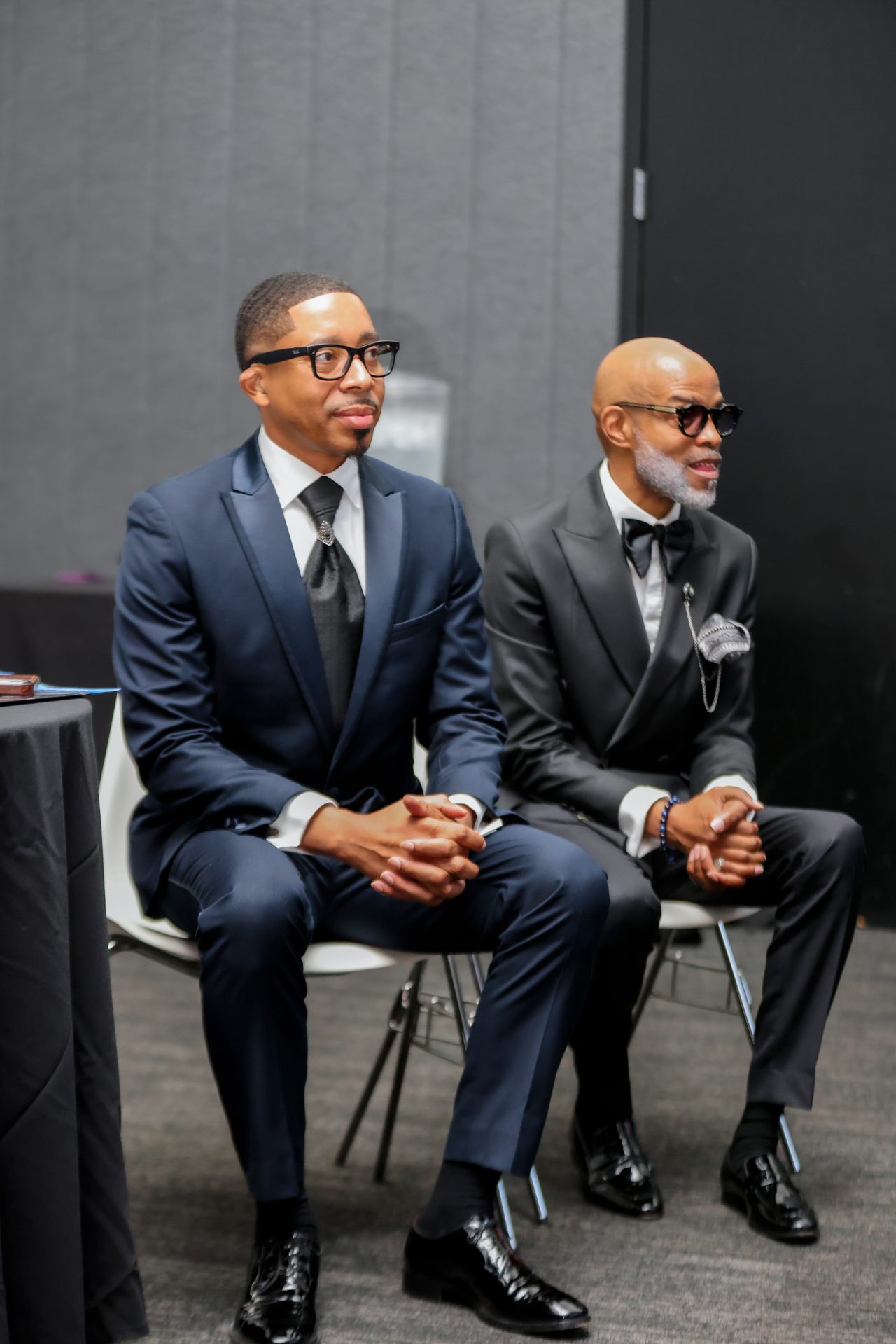 Two men in suits seated for an interview at the Ovation Awards