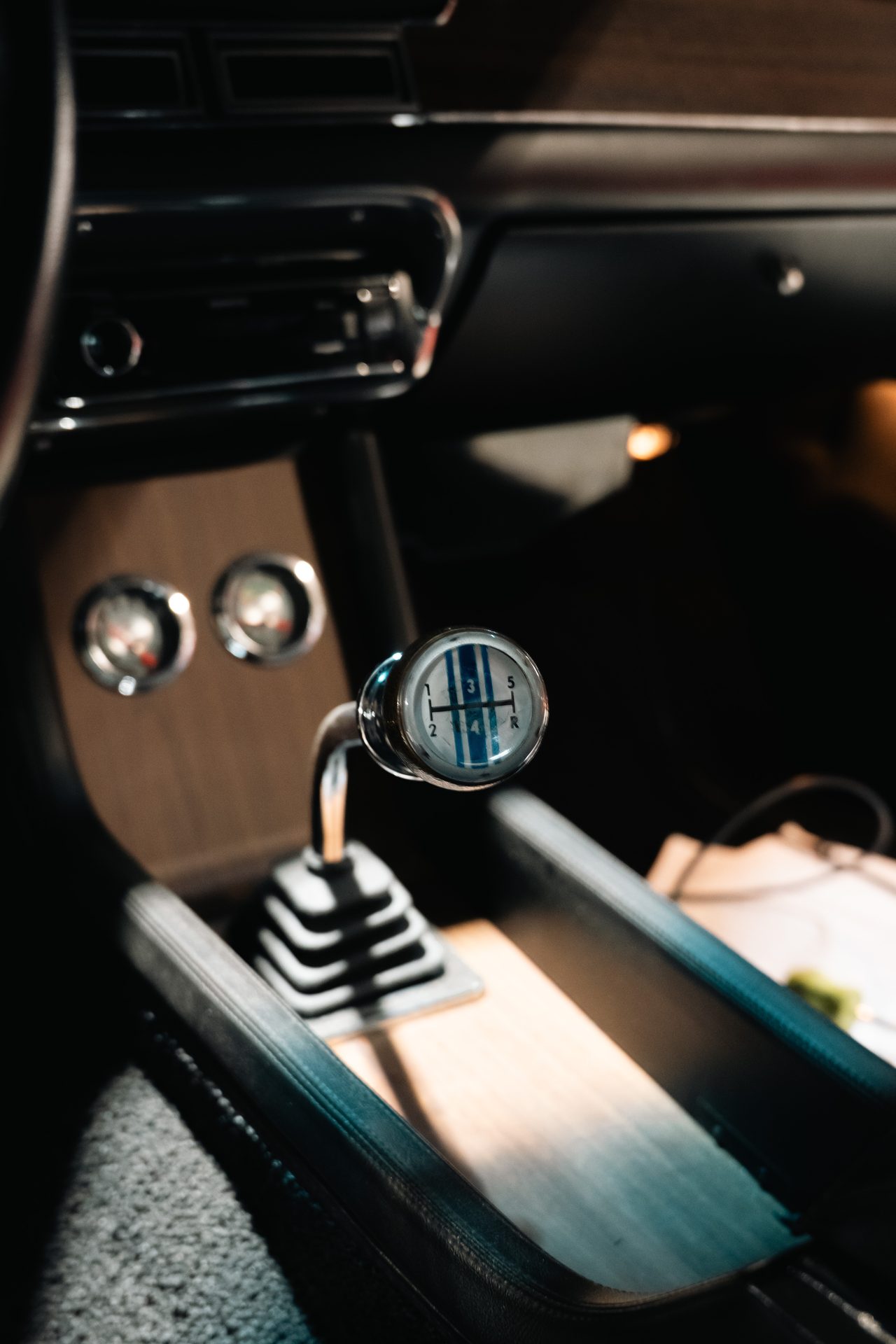 Shifter and wood grain console inside a classic Mustang