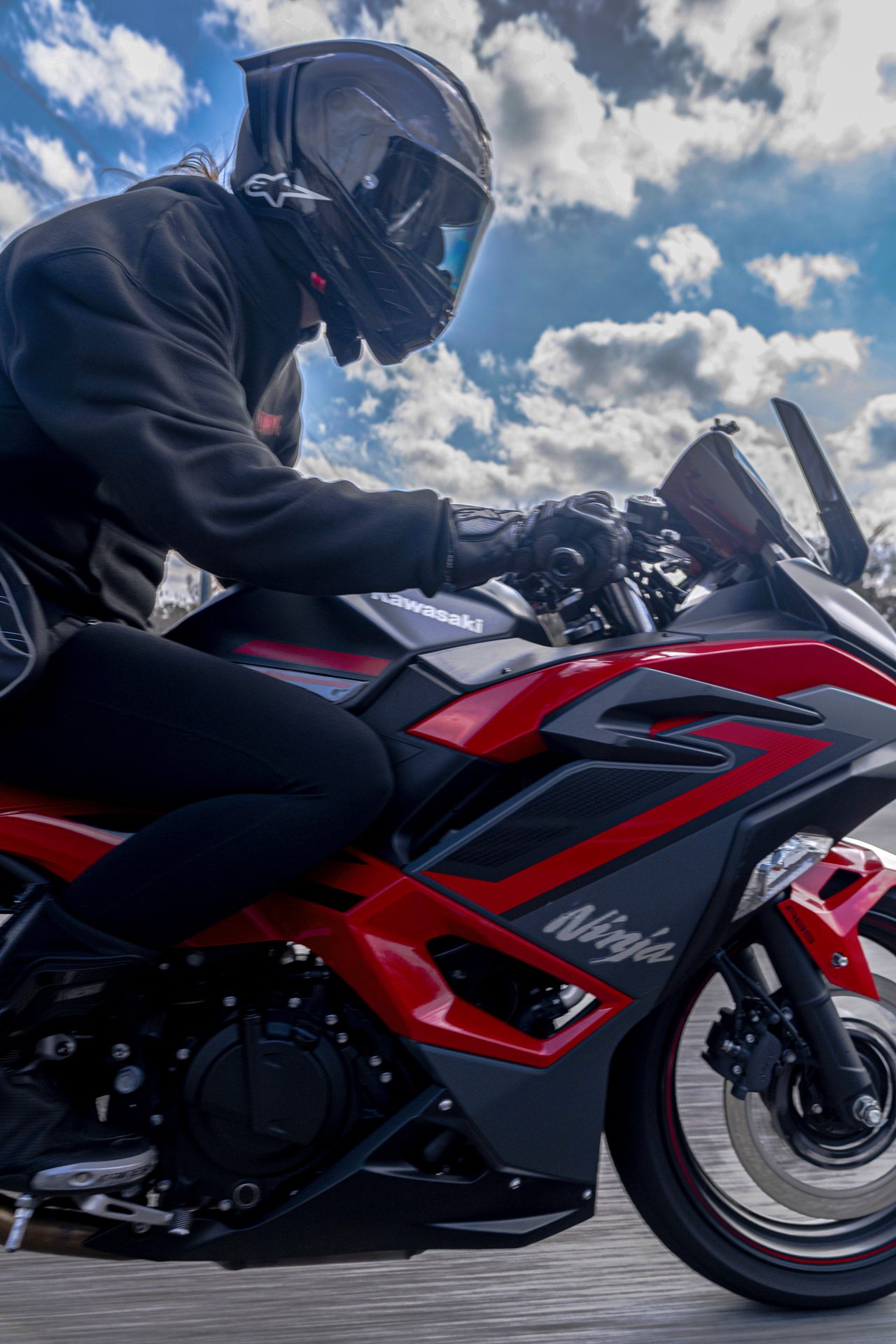 Rider on a red sport bike shot from a low angle at highway speed