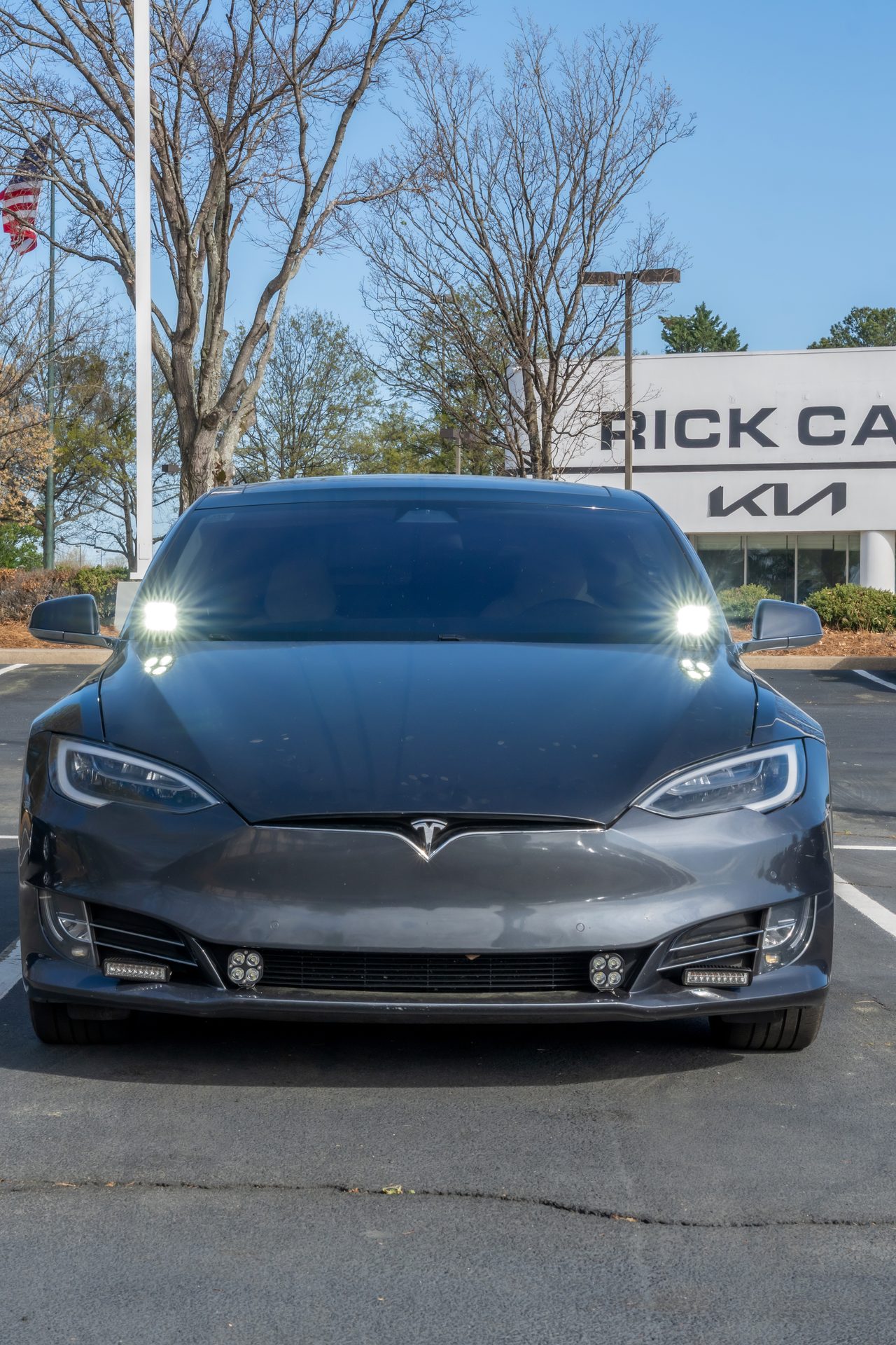 Grey Tesla Model S front on with amber lights on