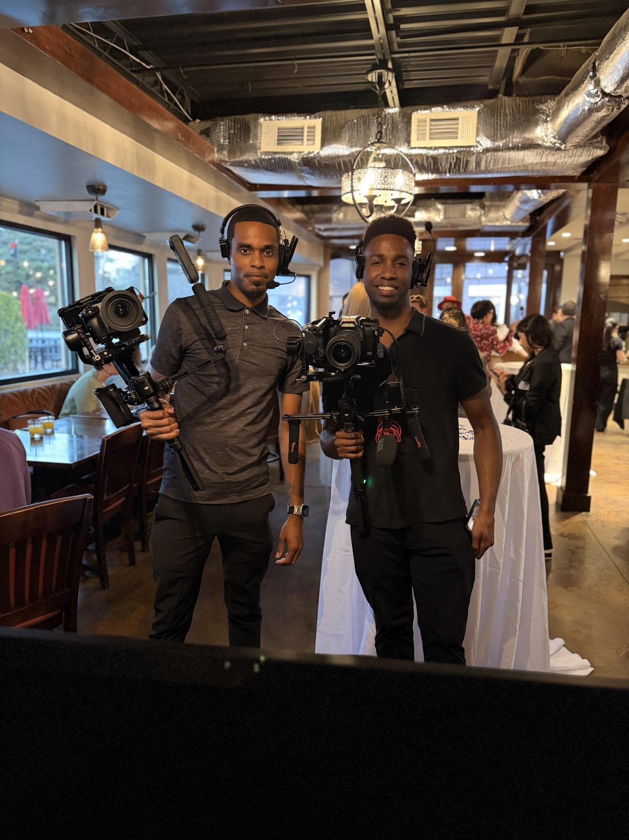 Mosi Nurdeen holding a cinema rig in a crowded venue