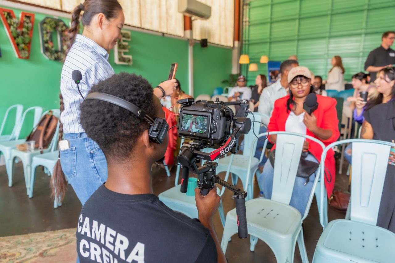 Crew member on a gimbal rig filming guests at a FreshBooks event