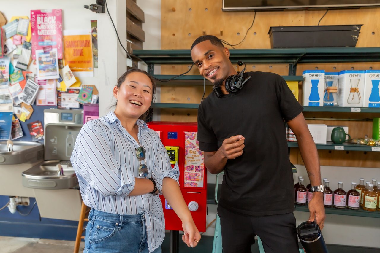 Crew member and client laughing at a counter